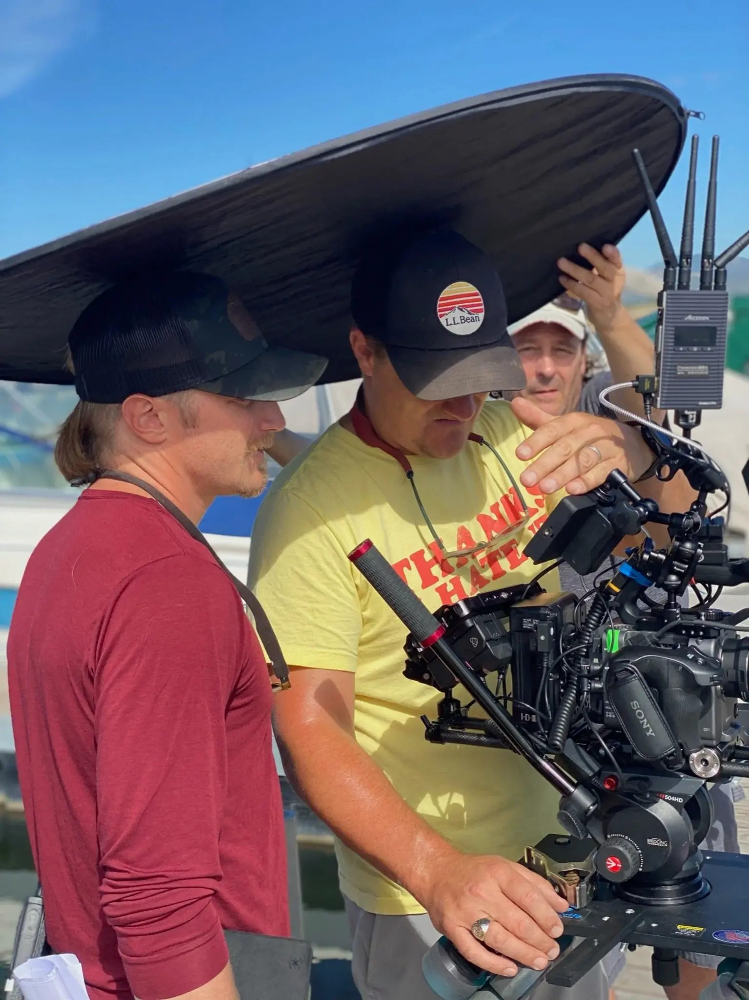 Video production team setting up cinema camera