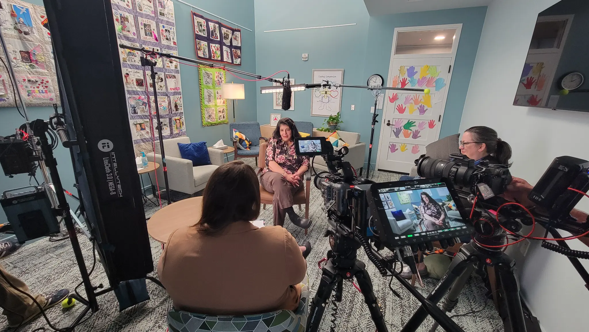 Video production team filming corporate testimonial